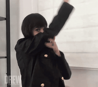 Woman In Black Jacket Dancing In Front Of Drew Board GIF