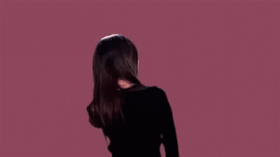 Woman In Black Jacket Dancing With Wind-Blown Hair GIF