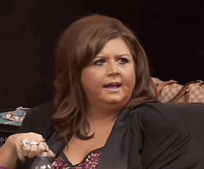 Woman In Black Jacket Holding Bottle GIF