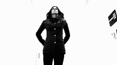 Woman In Black Jacket Holding Two Sticks GIF