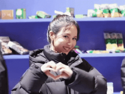 Woman In Black Jacket Making Heart Shape GIF