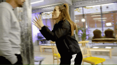 Woman In Black Jacket Next To Man In White Shirt GIF