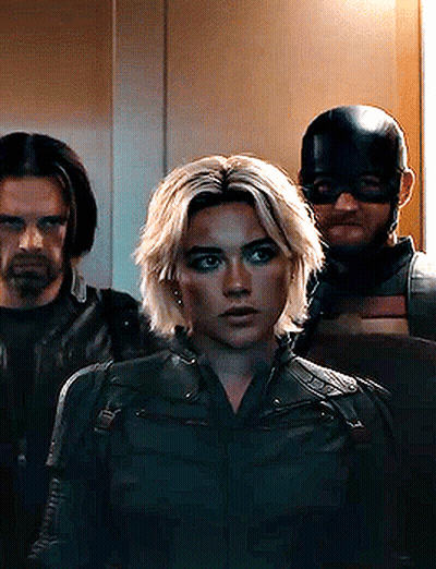 Woman In Black Jacket Next To Two Men GIF