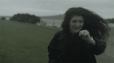 Woman In Black Jacket Running In Field GIF