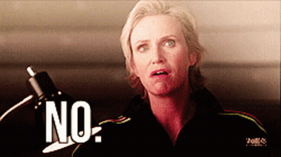 Woman In Black Jacket Saying No In Front Of Lamp GIF
