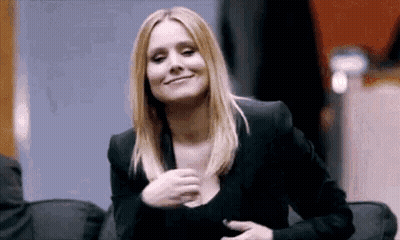 Woman In Black Jacket Smiling Holding Chest GIF