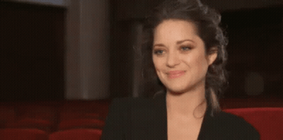Woman In Black Jacket Smiling In Red Chair Theater GIF
