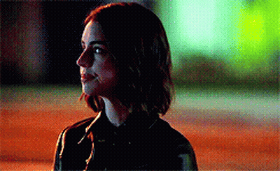 Woman In Black Jacket Standing In Dark Room GIF