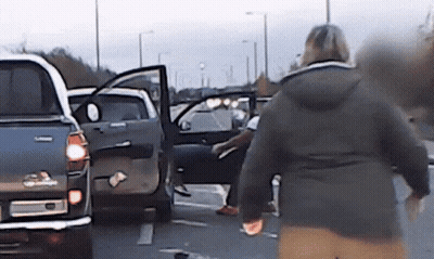 Woman In Black Jacket Walking Toward Toyota Truck GIF