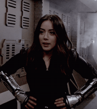 Woman In Black Jacket With Metal Gloves GIF
