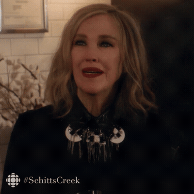 Woman In Black Jacket With Schitts Creek Hashtag GIF