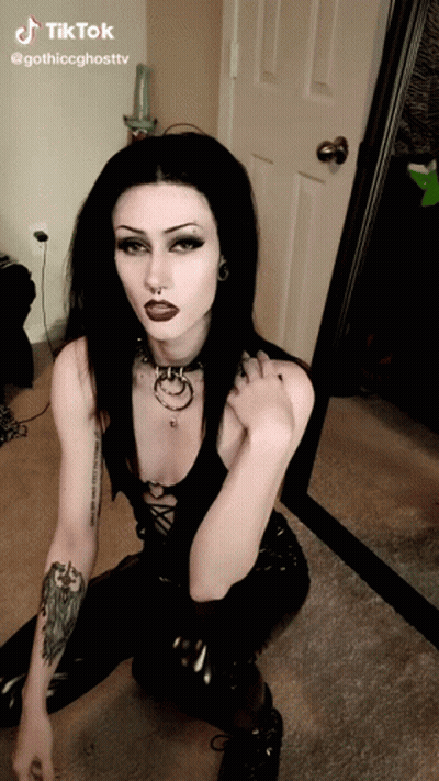 Woman In Black Kneeling Before Mirror GIF