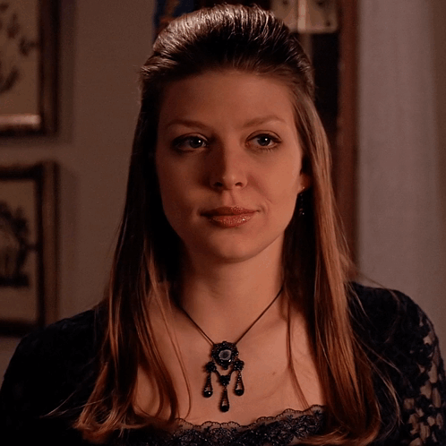 Woman In Black Lace Top And Pendant Necklace GIF