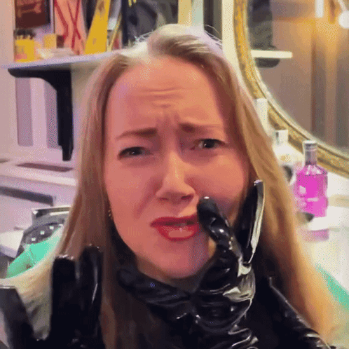 Woman In Black Latex Gloves Making Face GIF
