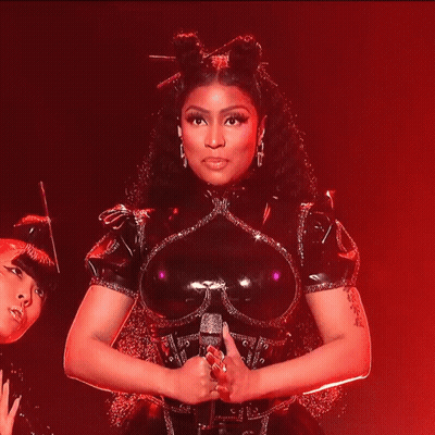 Woman In Black Latex Smiling Holding Microphone GIF