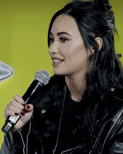 Woman In Black Leather Jacket Holding Microphone GIF