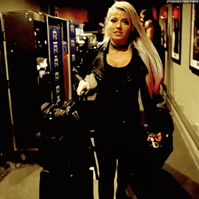 Woman In Black Leather Jacket Holding Suitcase In Hallway GIF