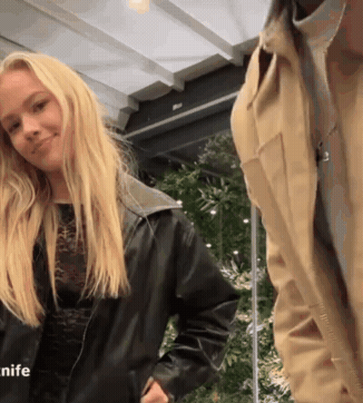 Woman In Black Leather Jacket Next To Man In Tan Jacket GIF