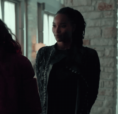 Woman In Black Leather Jacket Next To Woman In Red Jacket GIF