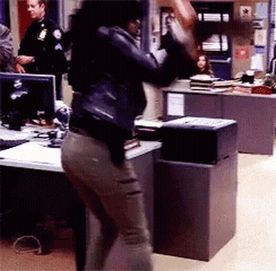 Woman In Black Leather Jacket Standing At Desk GIF