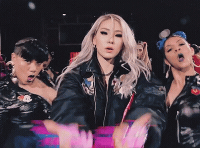 Woman In Black Leather Jacket Surrounded By Women GIF