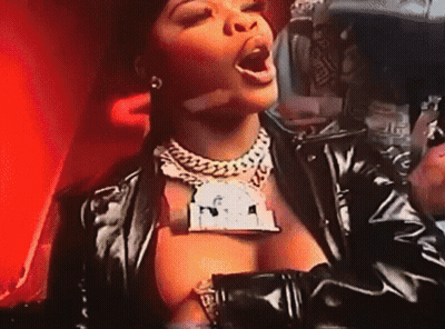 Woman In Black Leather Jacket With Dollar Sign Necklace GIF