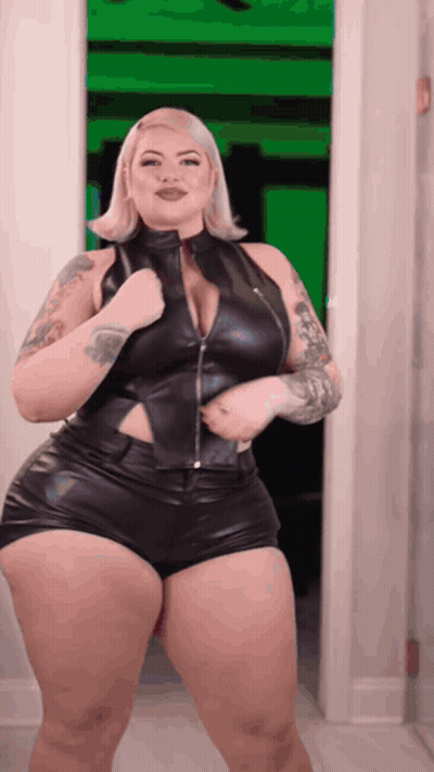 Woman In Black Leather Outfit Standing In Doorway GIF