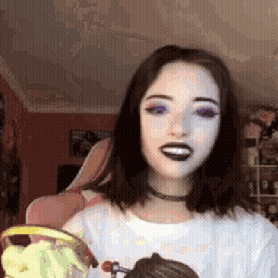 Woman In Black Lipstick And Choker Smiling With Cupcake GIF