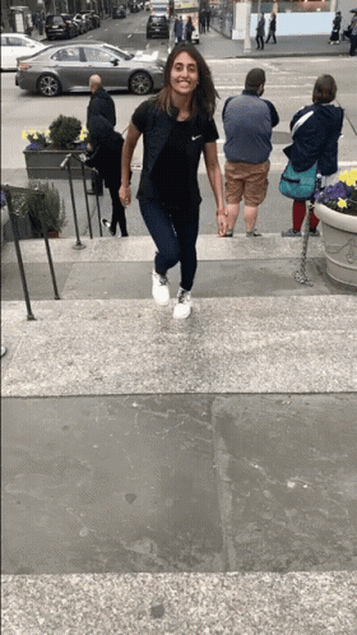 Woman In Black Nike Shirt Walking Down Stairs GIF