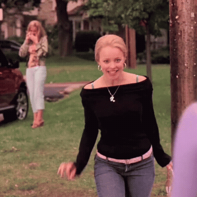 Woman In Black Off Shoulder Top And Jeans Smiling In Park GIF