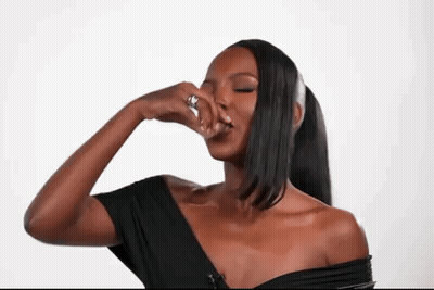 Woman In Black Off Shoulder Top Covering Nose With Hand GIF