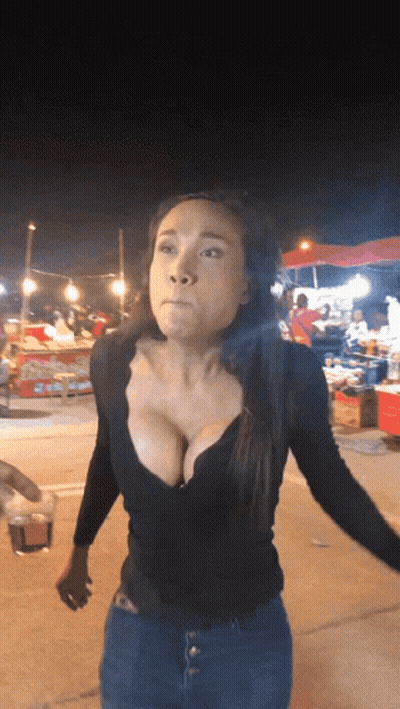 Woman In Black Plunging Top At Food Stand GIF
