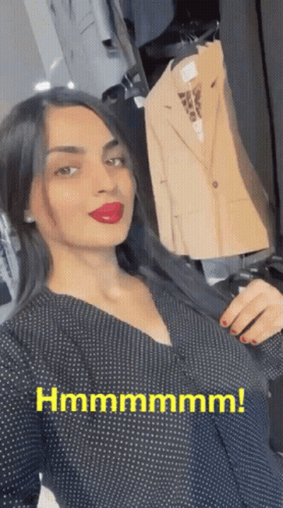 Woman In Black Polka Dot Dress Holding Jacket Beside Hanger Hmmmmmm GIF