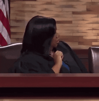 Woman In Black Robe Sitting At Table GIF