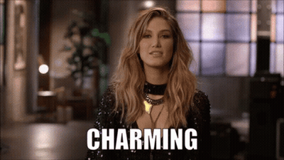 Woman In Black Sequined Top With Charming Sign GIF