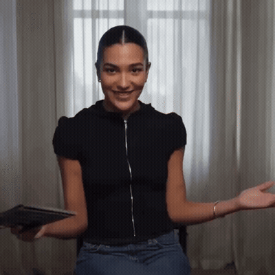 Woman In Black Shirt And Blue Jeans Sitting By Window GIF