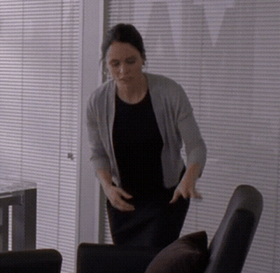 Woman In Black Shirt And Grey Cardigan GIF