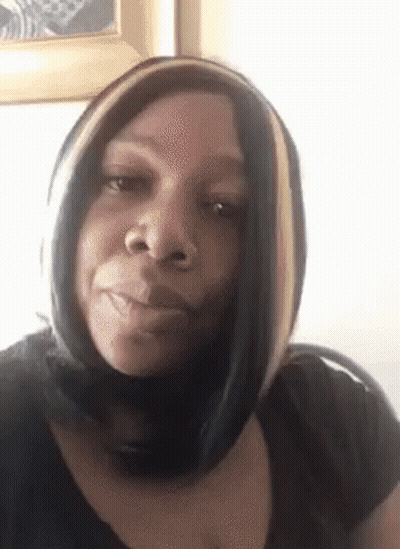 Woman In Black Shirt And Scarf Making Funny Face GIF