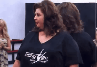 Woman In Black Shirt At Mirror GIF