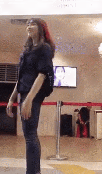 Woman In Black Shirt By Atrium Sign GIF
