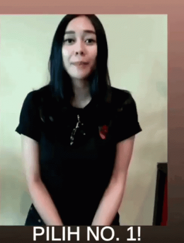 Woman In Black Shirt In Front Of Pilih No. 1 Sign GIF