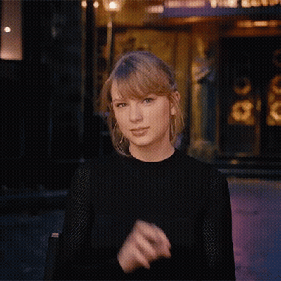 Woman In Black Shirt Making Funny Face With Hands GIF
