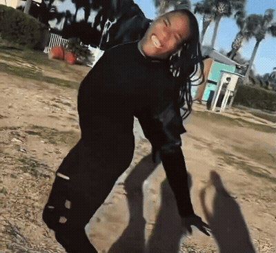 Woman In Black Shirt Smiling And Dancing GIF