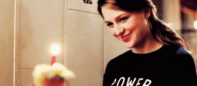 Woman In Black Shirt Smiling Holding Birthday Cake With Candle GIF