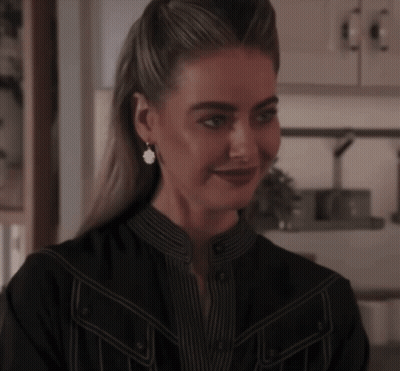 Woman In Black Shirt Smiling With Earrings GIF