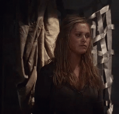 Woman In Black Shirt Standing In Dark Room GIF