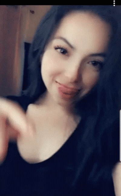 Woman In Black Shirt Sticking Tongue Out GIF