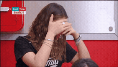Woman In Black Shirt With Amici Covering Face GIF
