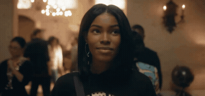 Woman in Black Shirt With Crown Looking at Camera