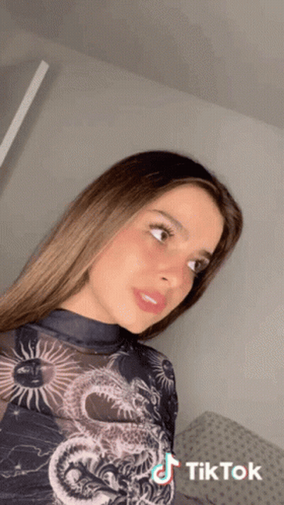 Woman In Black Shirt With Dragon And TikTok Logo GIF